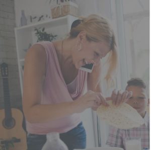 woman at home with child while talking on the phone 1