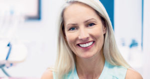 A blonde middle-aged woman smiling warmly