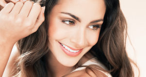 Woman smiles and looks to downward to the left