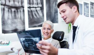 dental patient looking at the digital x-ray with the dentist